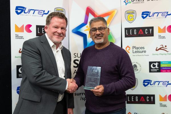 Baiju Nakarja collecting award for Keith Ross the winner of outstanding service to sport award with sponsor Places Leisure