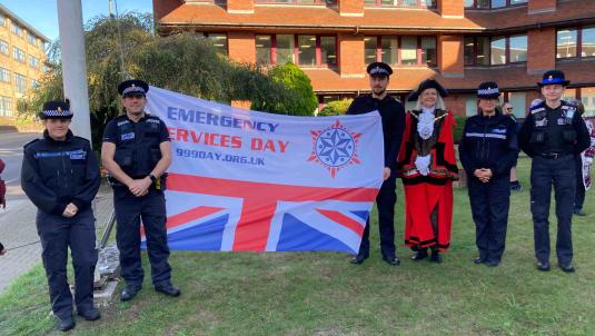 Surrey Heath Mayor and 5 police officers with the Emergency Services Day flag