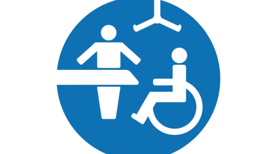 Blue circle with white icons of wheelchair hoist and table
