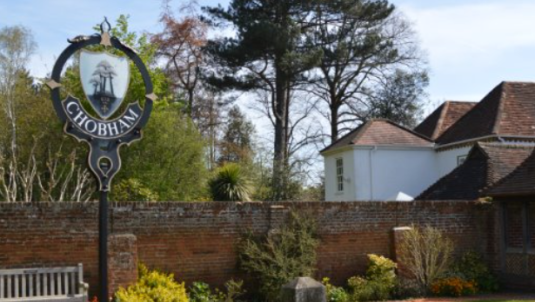 Chobham village sign with tree and house in background
