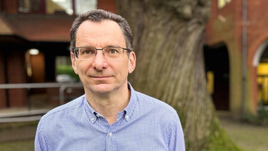 Headshot of council Leader Cllr Shaun Macdonald with tree in background