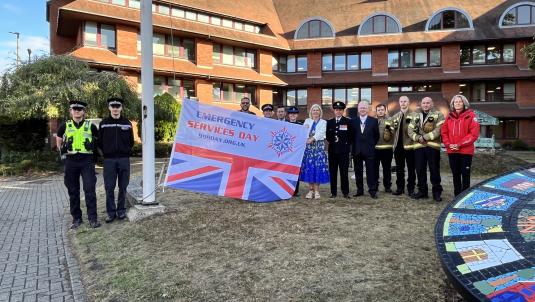 Emergency services and former Mayor with 999 Day flag