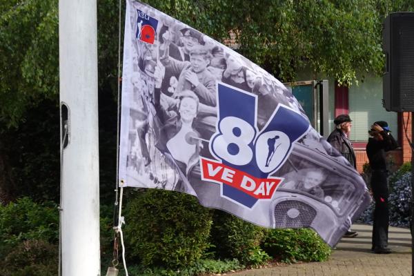 Close up of VE Day 80 flag on pole
