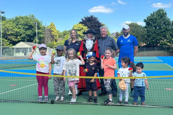 Group of children with the Mayor, consort, and representatives of LTA and NTA on a tennis court