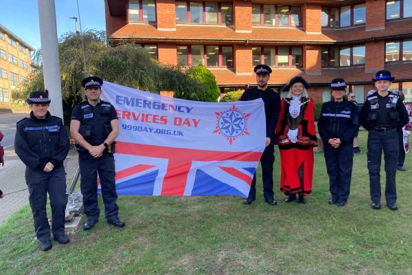 Surrey Heath Mayor and 5 police officers with the Emergency Services Day flag