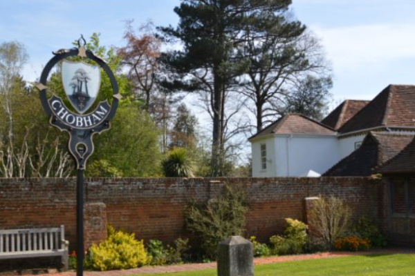 Chobham village sign with tree and house in background
