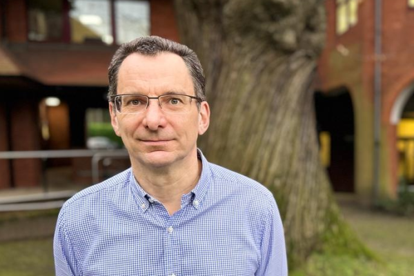 Headshot of council Leader Cllr Shaun Macdonald with tree in background