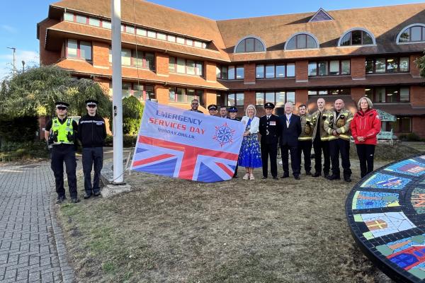Emergency services and former Mayor with 999 Day flag