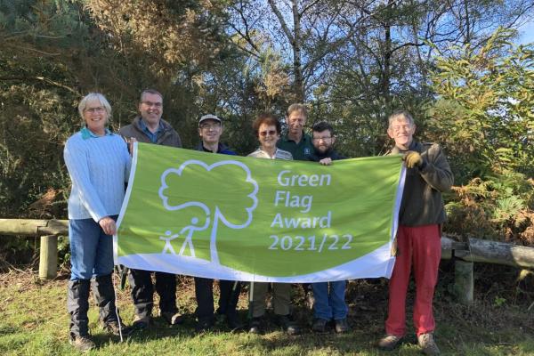 Conservation volunteers at Lightwater Country Park with the Green Flag 2021