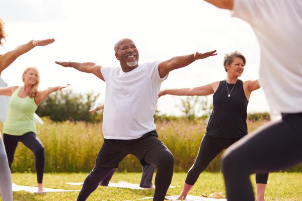 group of people participating in a fitness class in the park