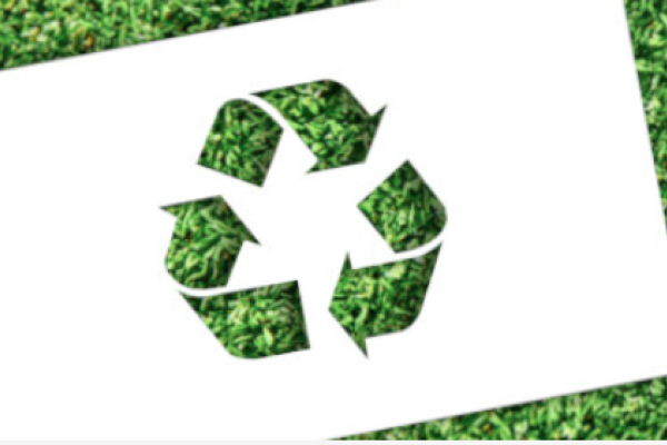 Recycling logo on grass