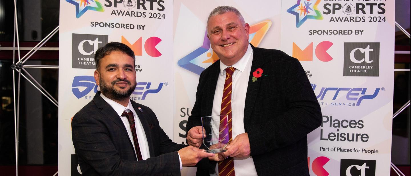Representative from Frimley Phoenix Cricket Club with award sponsor, Surrey Security Services