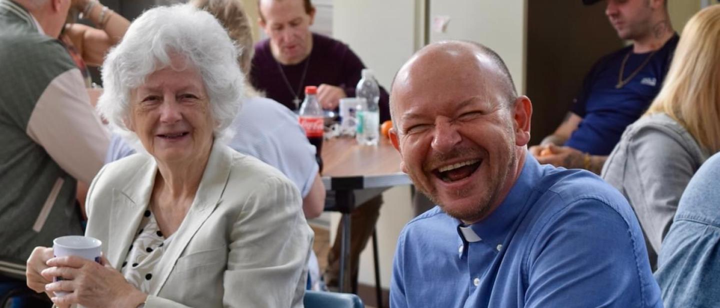 two people enjoying the community breakfast