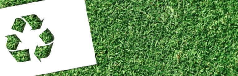 Recycling logo on grass