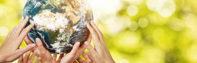 [Multiple hands holding up a model of the Earth]