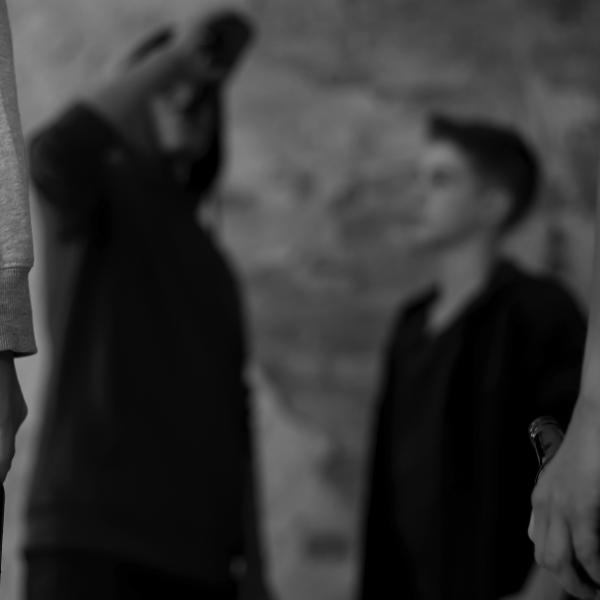 Stock black and white image of young men engaging in ASB.