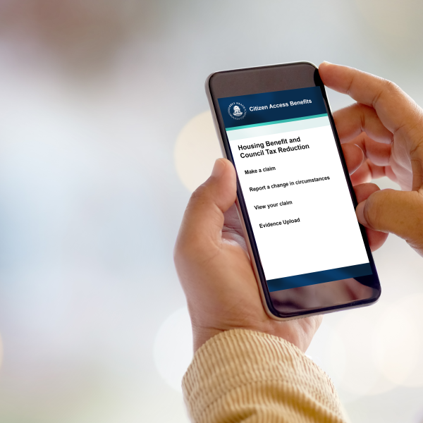 A person looking at the new planning benefit and council tax reduction page on their phone.