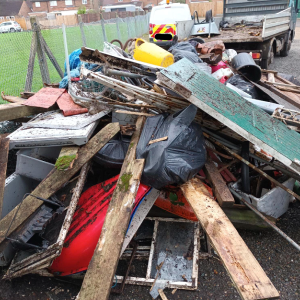 fly tip of various items including wood, windows and bins