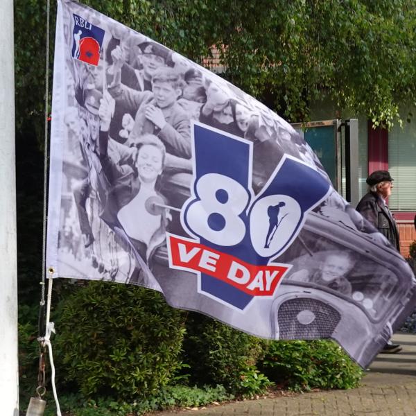 Close up of VE Day 80 flag on pole