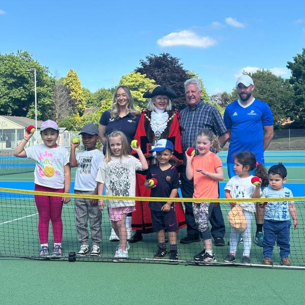Group of children with the Mayor, consort, and representatives of LTA and NTA on a tennis court