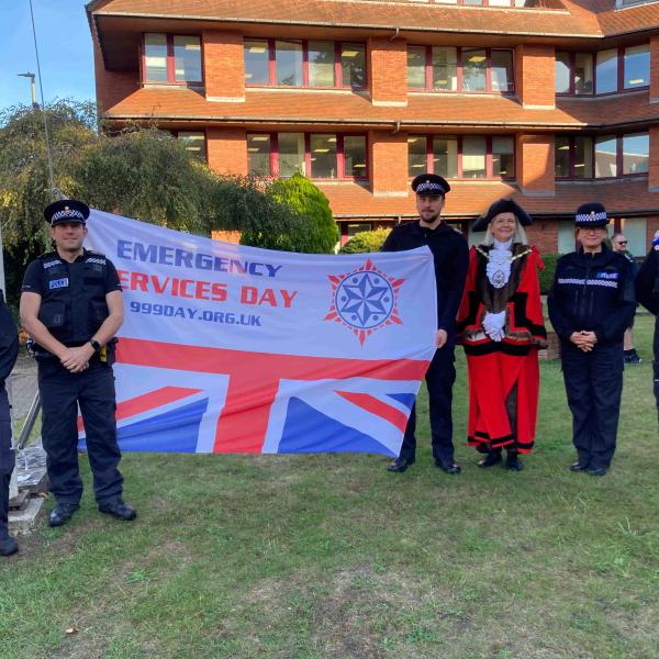 Surrey Heath Mayor and 5 police officers with the Emergency Services Day flag