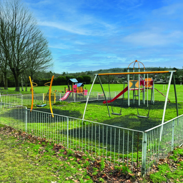 Frimley Green playground with swings, slide and other equipment