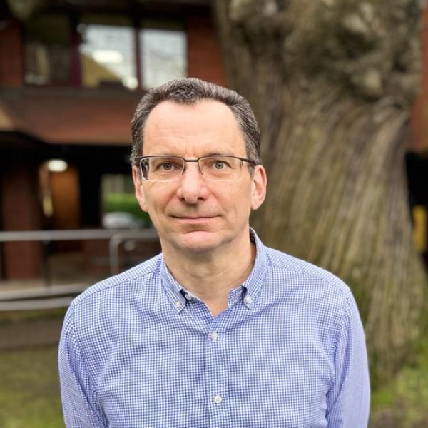 Headshot of council Leader Cllr Shaun Macdonald with tree in background