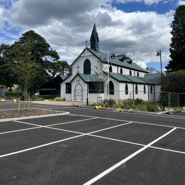 White church, cap parking spaces in foreground
