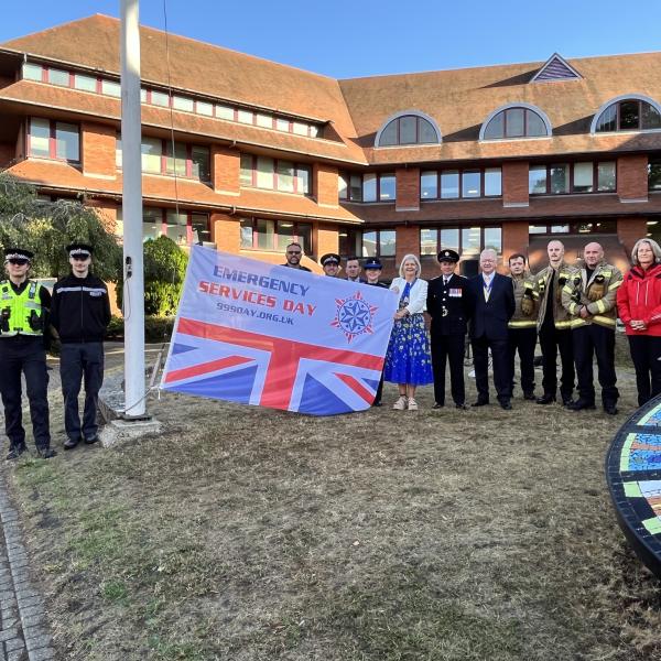 Emergency services and former Mayor with 999 Day flag
